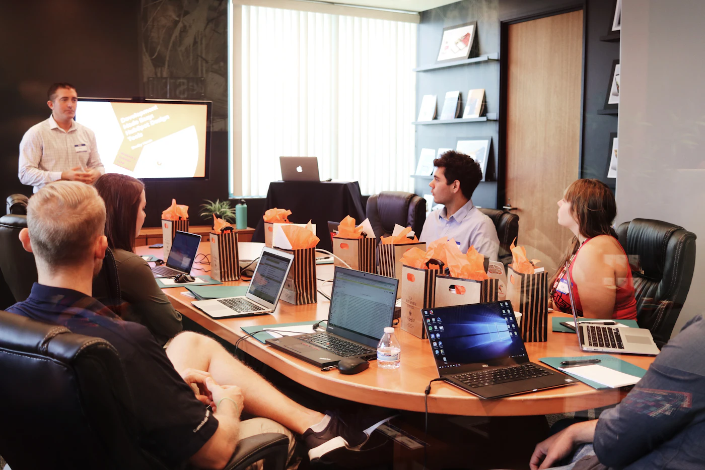 A consultant presenting digital strategy to a client team in a boardroom